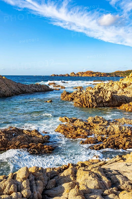 Landscape of the coastline with blue water at Marinedda Coast on a sunny day, Sardinia, Italy