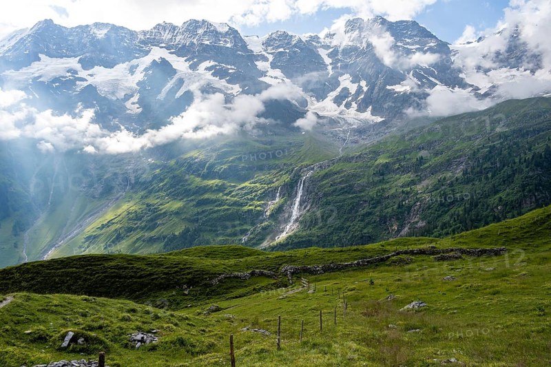 Picturesque mountain landscape with Schmadribachfall waterfall, Breithorn and Tschingelhorn mountain peaks, Bernese Alps, Bernese Oberland, Switzerland