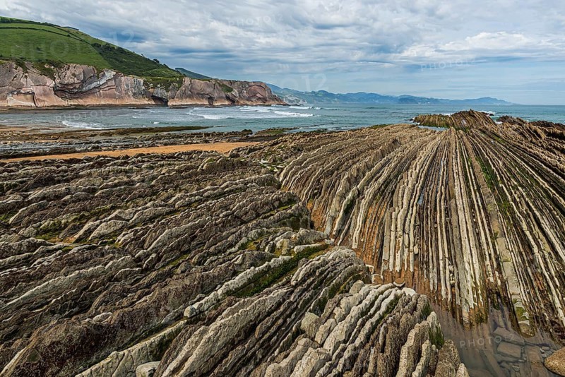 Distinctive rock cliffs as a geological formation of rock layers, Flysch on Itzurun Beach in Zumaia, Spain