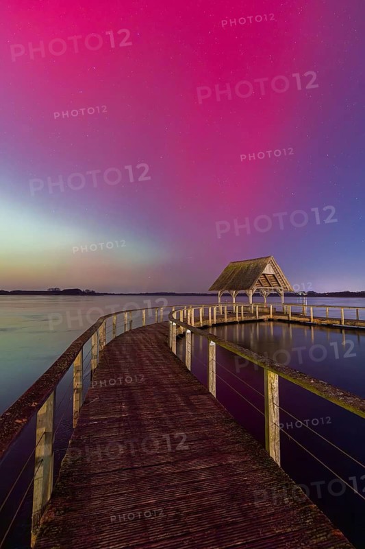 Wooden jetty and Northern Lights, Aurora borealis, polar lights over Lake Hemmelsdorf, Hemmelsdorfer See near Lübeck, Schleswig-Holstein, Germany