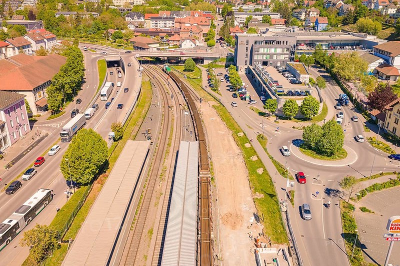 Aerial view of railway tracks in a city with surrounding roads, vehicles and buildings in sunshine, electrification of the Hochrheinbahn, conversion of the railway station, Waldshut, Tiengen, Germany