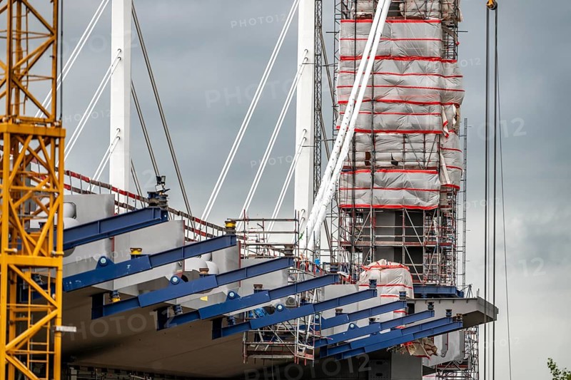 New construction of the second Neuenkamp motorway bridge of the A40, across the Rhine near Duisburg, parallel to the existing first bridge, the bridge pillars have already been partially built, the first bridge segments have already been completed and have already been moved towards the river on both sides of the Rhine, complete completion is planned for 2028, North Rhine-Westphalia, Germany