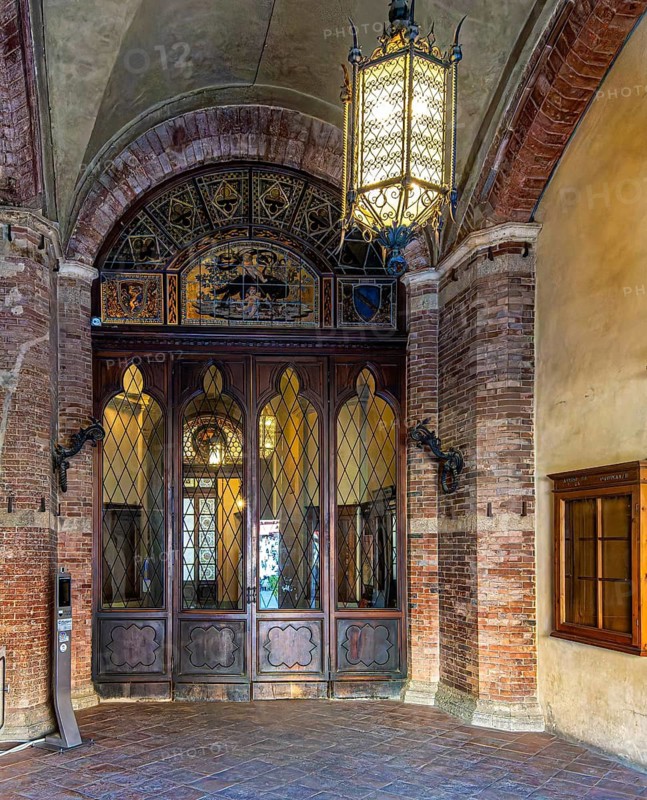 Entrance gate to the Gothic Town Hall Palazzo Pubblico on Piazza del Campo Pubblico, Siena, Tuscany, Italy