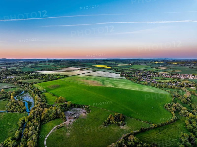 Sunset of Fields and Farms over Horsebridge nad Stockbridge from a drone, Hampshire, England, United Kingdom