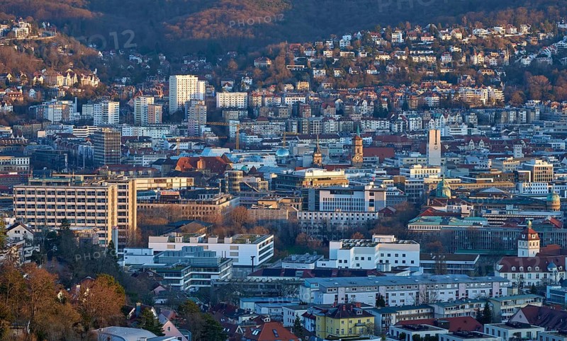 Panoramic view of Stuttgart city center in Germany during spring with warm golden evening light. Dense urban architecture, hills and residential districts captured from an elevated viewpoint, Stuttgart, Baden-Wuerttemberg, Germany