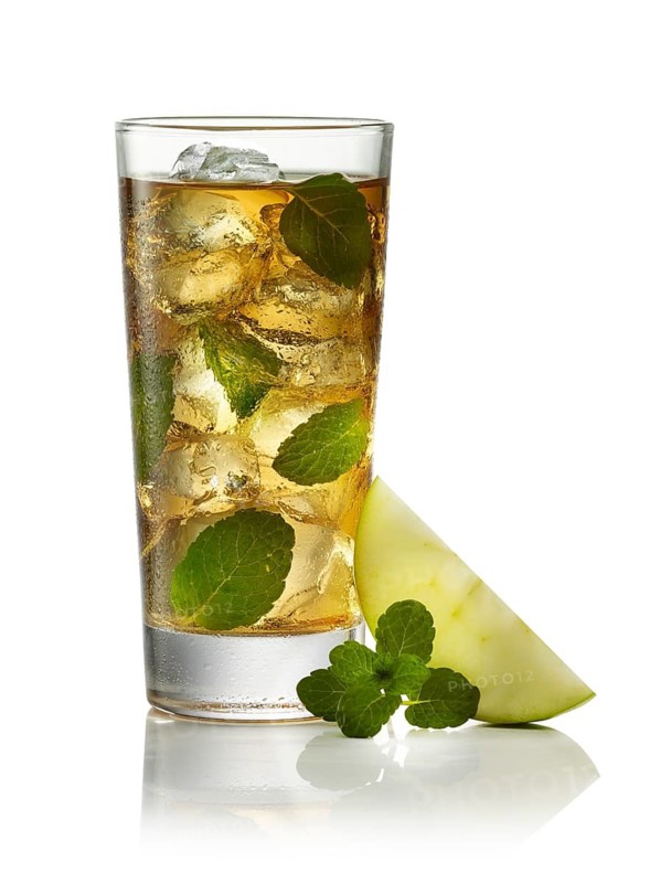 Clear cocktail on ice cube cubes against a white background, mint leaves and apple wedge as garnish, studio shot