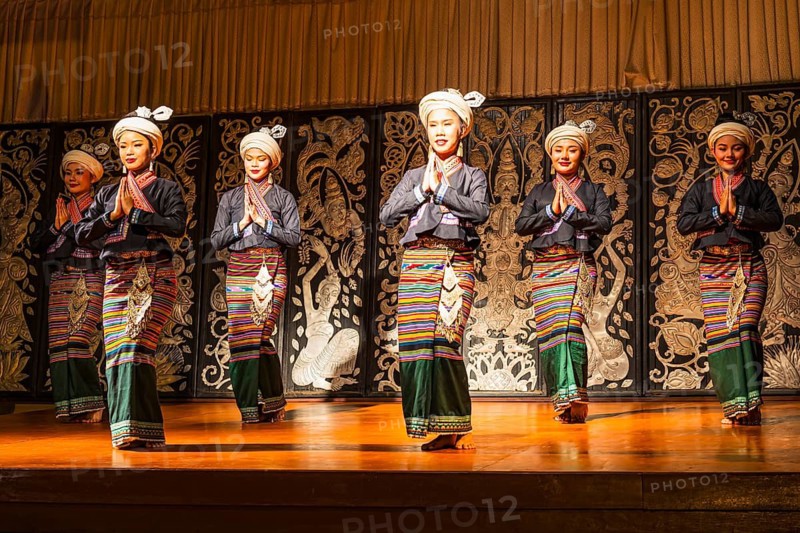 Young Thai women in traditional dress showing a traditional dance, Old Chiang Mai Cultural Center, Chiang Mai, Thailand