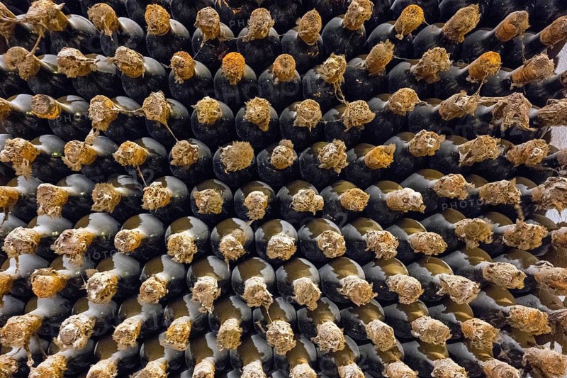 Close-up of stacks of wine bottles with corks showing symmetry and textures in an old cellar, wine cellar, Milestii Mici Winery, Mile?tii Mici, Republic of Moldova, Moldova