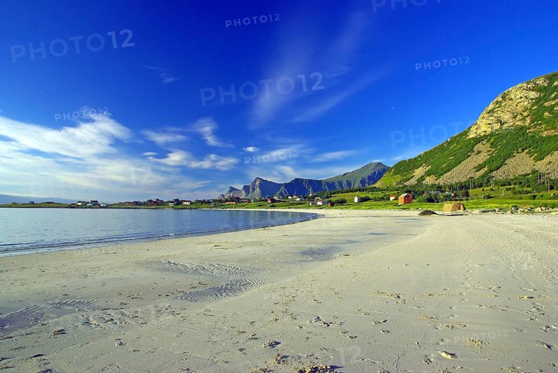 White sandy beach on the coast under blue sky with calming atmosphere, Ramberg, Flakstad, Nordland, Norway
