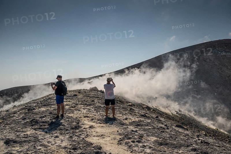 Tourists stand at the crater rim and photograph rising sulfur clouds, Vulcano, Aeolian or Lipari islands, Sicily, southern Italy, Italy