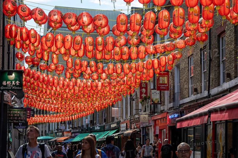 Red Chinese lanterns suspended over street in Chinatown, Gerard Street, Soho, London, England, UK