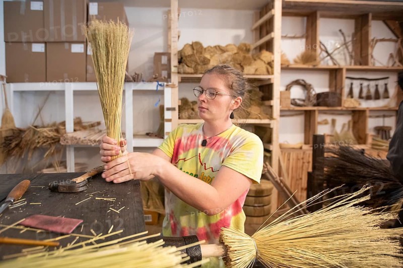 Berea, Kentucky - June Rosenbarkr makes traditional Appalachian brooms and whiskbrooms, by hand at Sunhouse Craft. They use broomcorn, a type of sorghum, and distribute their products through wholesalers and direct to consumers