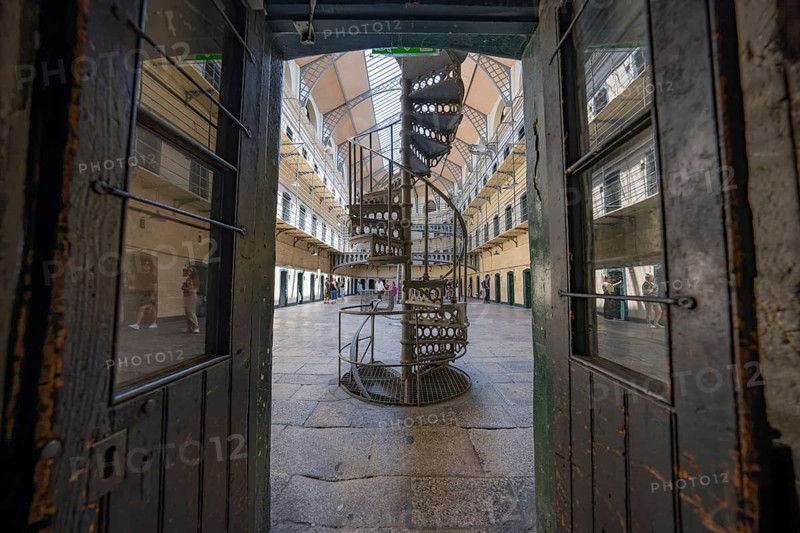 View through opened doors of a central spiral staircase in an old prison with industrial design, Kilmainham Gaol Prison, Dublin, Ireland