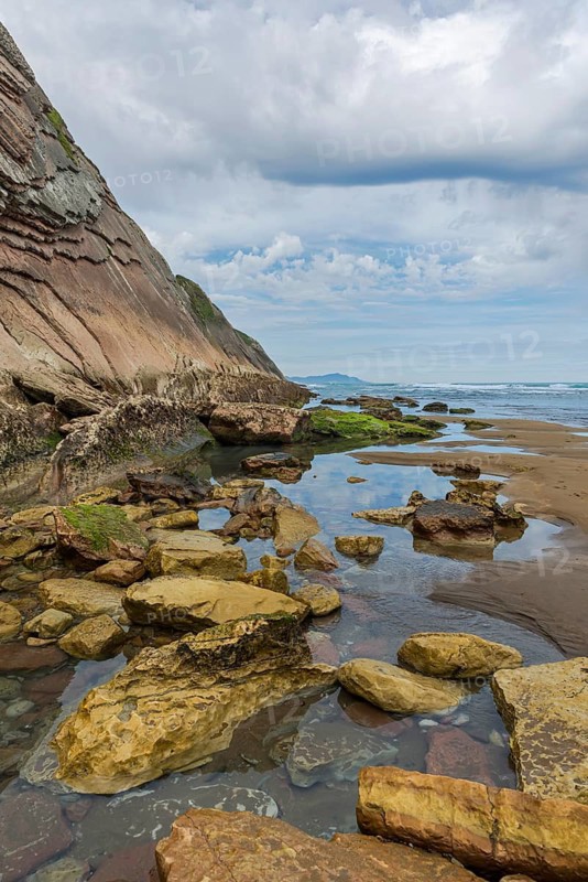 Distinctive rock cliffs as a geological formation of rock layers, Flysch on Itzurun Beach in Zumaia, Spain