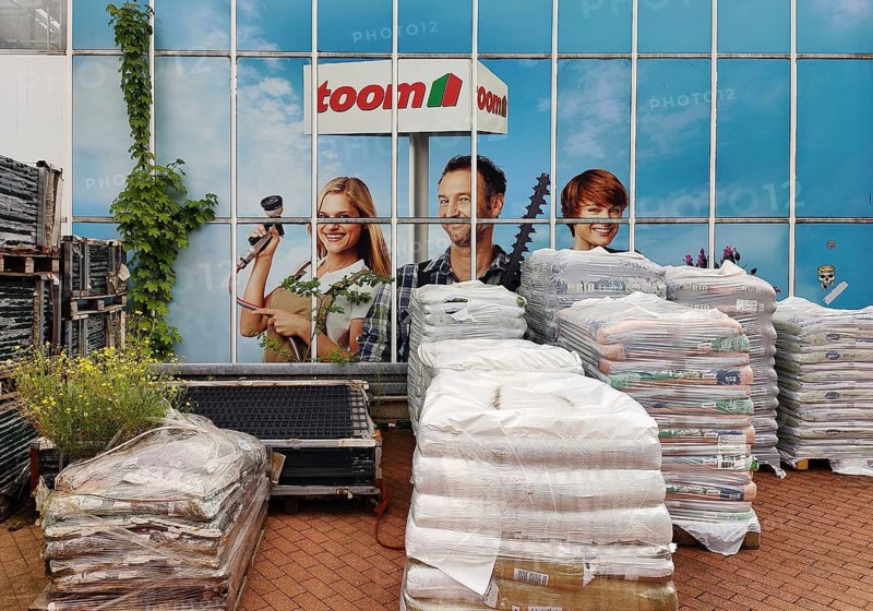 Goods for sale in front of an advertising photo at Toom Baumarkt, Witten, Ruhr region, North Rhine-Westphalia, Germany