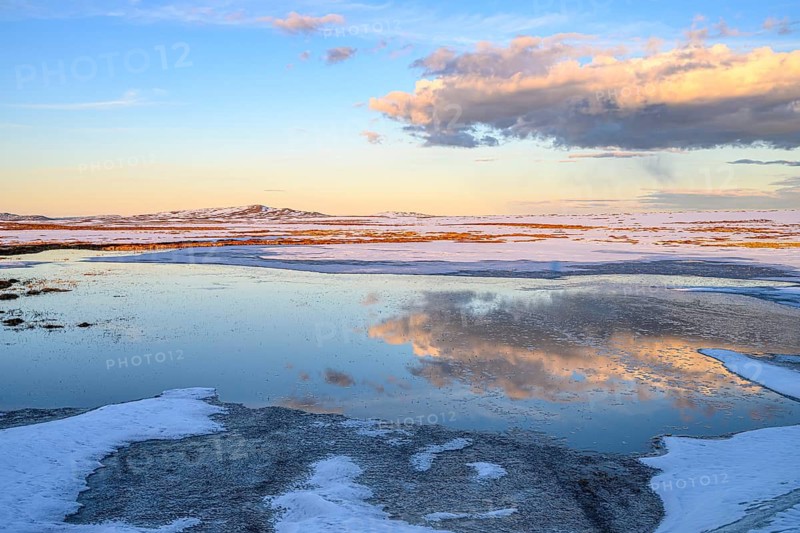 Storsjö Kapell, Jämtlands län, Sweden, snowy and icy landscape with water areas reflecting the sky and clouds on Sweden's highest pass road, Flatrüt, Berg, Härjedalen Län, Sweden