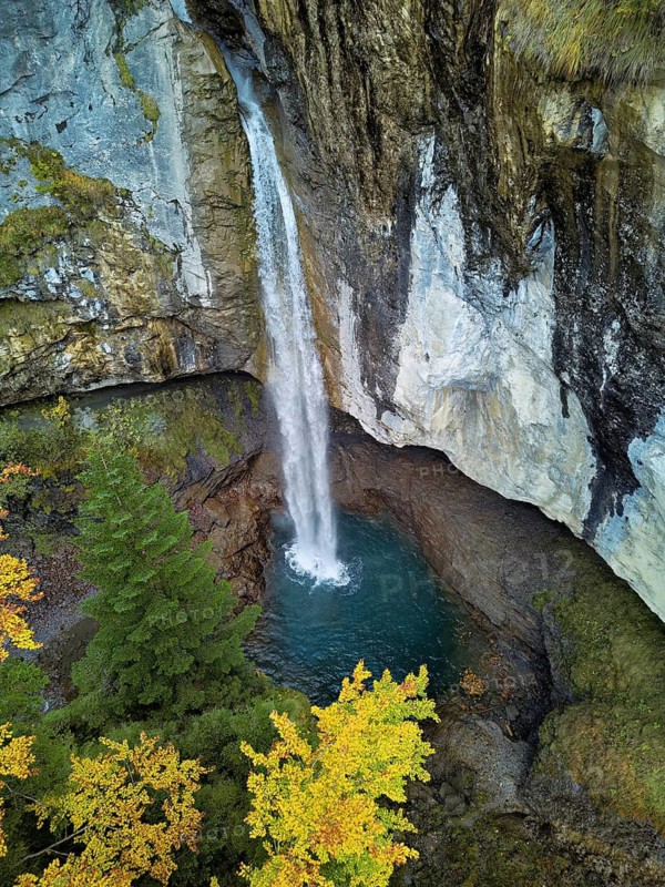 Aerial view of Berglistüber waterfall in autumn-colored surroundings, Linthal, Klausenpass, Canton of Glarus, Switzerland