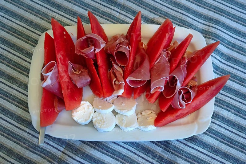 Sliced watermelon with ham and sheep cheese served on a platter, Bavaria, Germany
