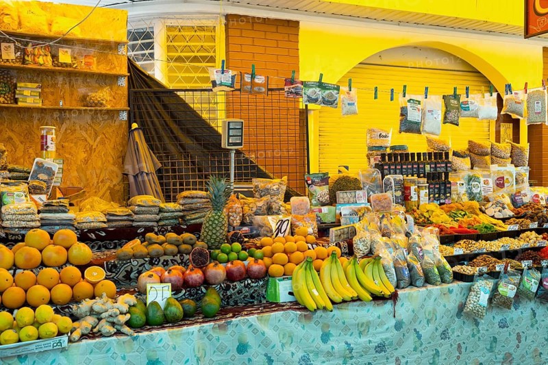 Colourful market stand with a variety of fresh fruit and products under bright lights, Central Market, Piata Centrala, Chisinau, Chisinau, Chisinau, Chisinau, Republic of Moldova, Moldova, Eastern Europe
