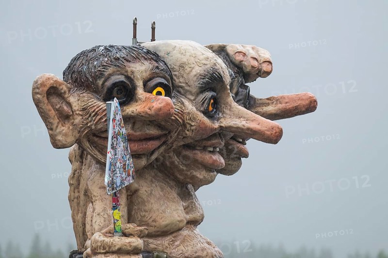 Oversized troll with three heads holding a sticky road sign, coach in the background, Trollstigen Camping, near Åndalsnes or Andalsnes, Rauma municipality in Møre og Romsdal province, Norway