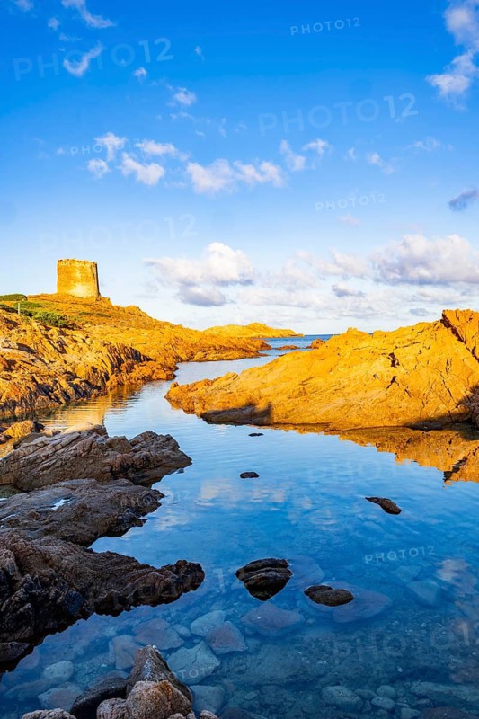 An old tower at the coast at Marinedda at sunset, Sardinia, Italy