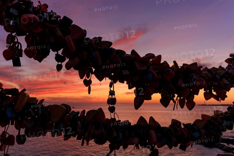 Lanzarote, Canary Islands, Spain, Europe, Playa Blanca, love castles, silhouettes of love locks in front of a romantic sunset over the ocean