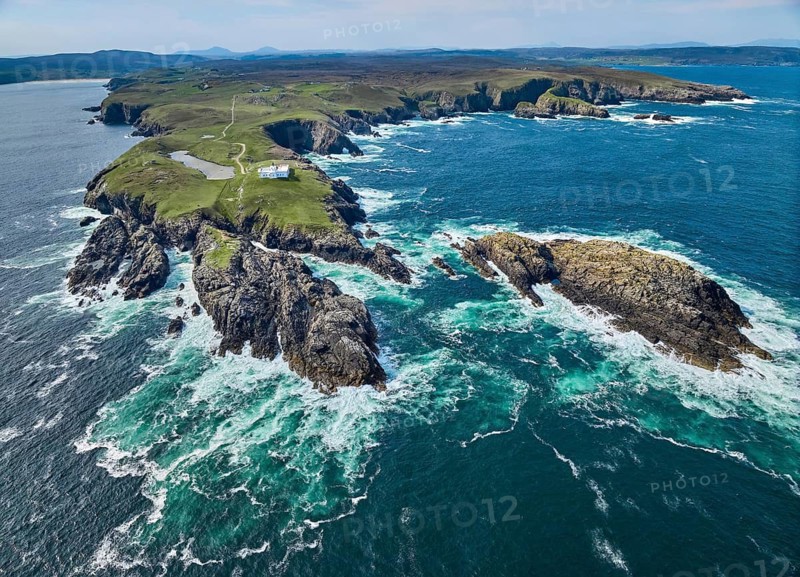 Aerial drone photo of Iighthouse on the rocky cliffs and heavy atlantic ocean surf, Strathy point, northern Scotland, UK