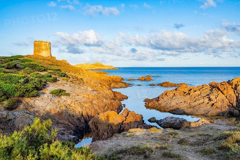 An old tower at the coast at Marinedda at sunset, Sardinia, Italy