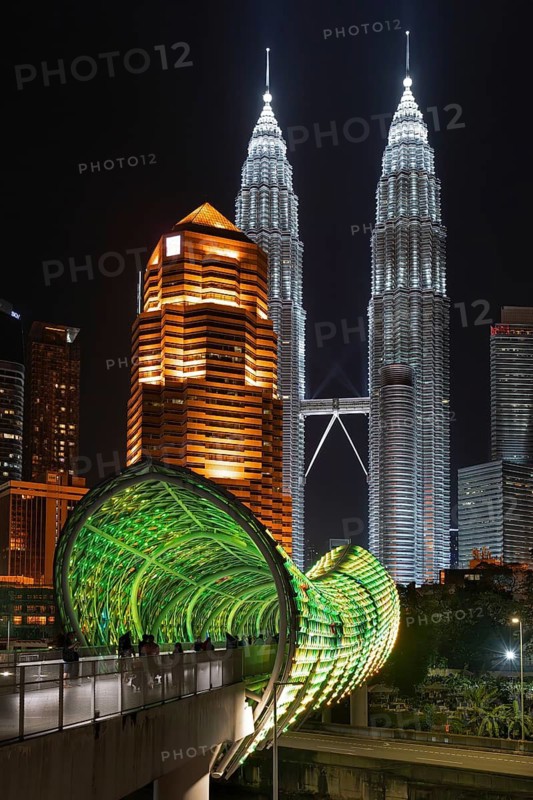 Saloma Link, Petronas Towers, KLCC Twin Towers and skyscrapers illuminated at night in capital city Kuala Lumpur, Malaysia