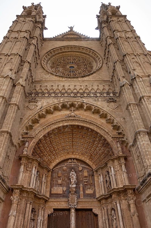 Palma Cathedral, also known as La Seu, is Palma's landmark and is one of the most important Gothic buildings in Europe. It was built from 1229 on the remains of a former mosque and impresses with its huge rose window and its location right by the sea. In the 20th century, Antoni Gaudí redesigned parts of the interior and gave the cathedral additional architectural accents, Palma, Majorca