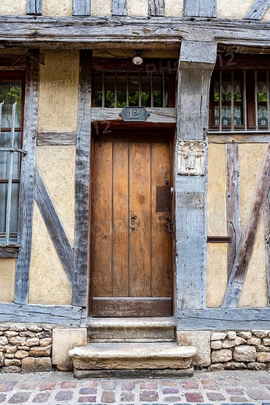 Old wooden door on a half-timbered house in the old town of Troyes, Aube department, Grand Est region, France