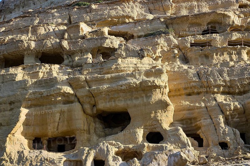 Neolithic caves, former hippie paradise, detail of eroded rock wall with small cave entrances and textures, Matala, south coast, Crete, Greek islands, Greece