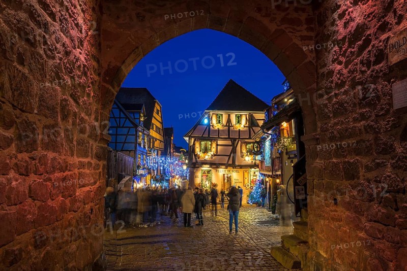 Colour-illuminated and Christmassy decorated half-timbered houses, blue hour, Christmas market, Riquewihr, Grand Est, Haut-Rhin, Alsace, France