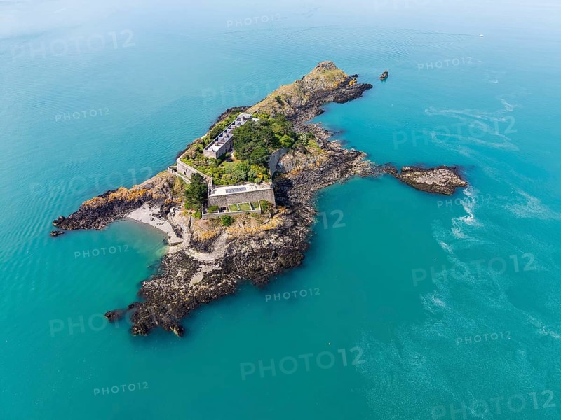 Aerial view of the historic Île des Rimains fortress island with the Fort des Rimains in the turquoise sea. The former lake-fort is located off the coast of the municipality of Cancale, Côte d'Émeraude, Emerald Coast, Ille-et-Vilaine department, Brittany, English Channel, France