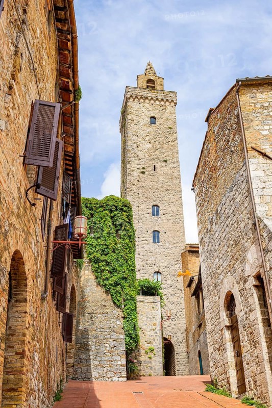 Tower of the old town with historic buildings at San Gimignano on a sunny day, Tuscany, UNESCO World Heritage, Italy, Europe, Europe