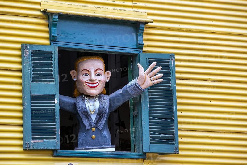 Painted figure waving from a shuttered window, La Boca, Buenos Aires, Argentina