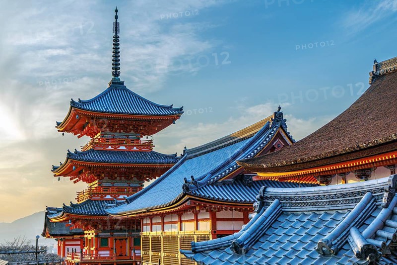 Kiyomizu-dera three-storey pagoda and rooftops at sunset, Kyoto, Japan