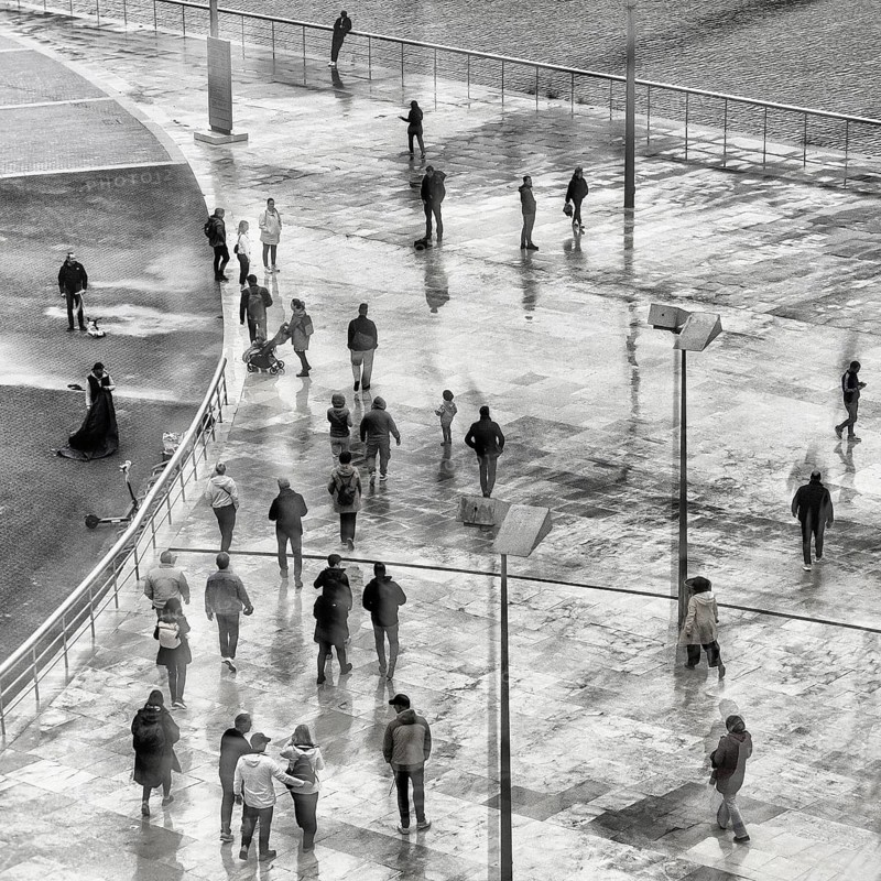 View of a crowd of people with window reflection and movement