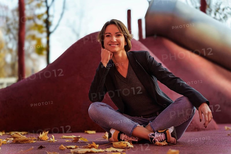 Young woman enjoying autumn at the playground