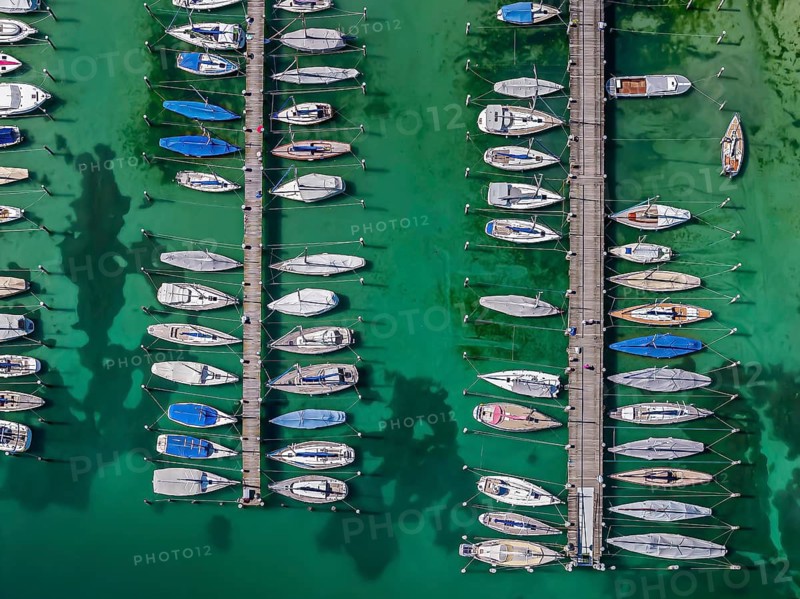 Marina of the Yacht Club Insel Reichenau. The lake bed can be seen in many shallow water zones. The water level of Lake Constance is currently low for the time of year. Reichenau, Baden-Württemberg, Germany