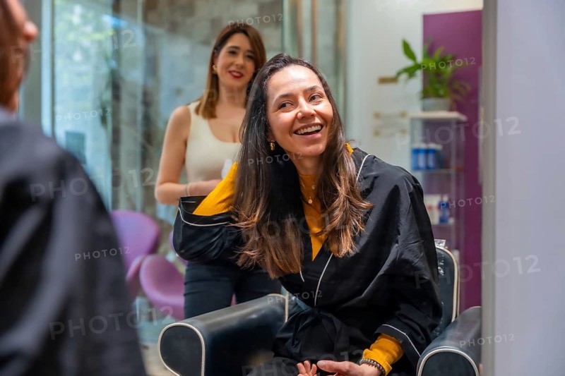 Happy woman smiling and enjoying her new style after a hair treatment at a beauty salon, feeling refreshed and confident with the cosmetic care experience