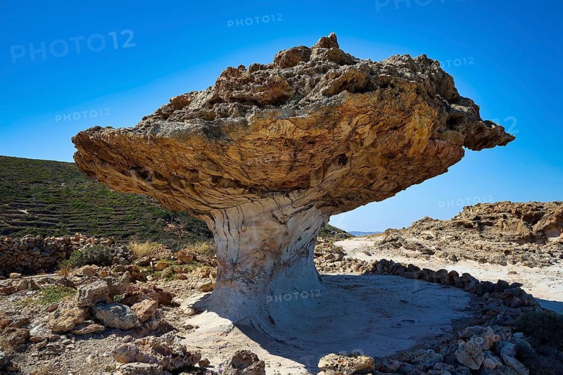 Single mushroom shaped rock casts shadow on the dry environment with blue sky, mushroom rock, mushroom rock, bizarre rock, rock formation, Skiadi, Kimolos, Cyclades, Greek Islands, Greece