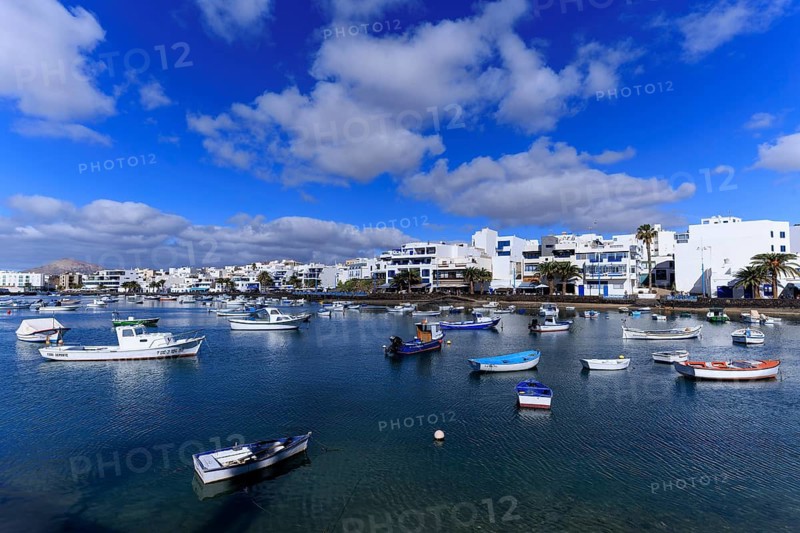 Lanzarote, Canary Islands, Spain, Europe, Charco San Gines harbour in Arrecife, various boats in the harbor of a coastal town, under a fascinating blue sky