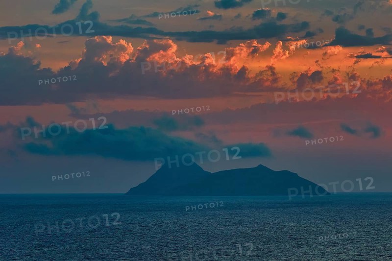 Paximadia island, colorful sunset over an island in the sea with dramatic cloud landscape, Matala, south coast, Crete, Greek Islands, Greece
