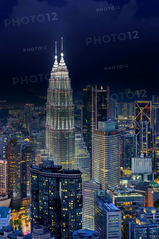 Petronas Towers, KLCC Twin Towers, interlinked 88-storey supertall twin skyscrapers illuminated at night in capital city Kuala Lumpur, Malaysia