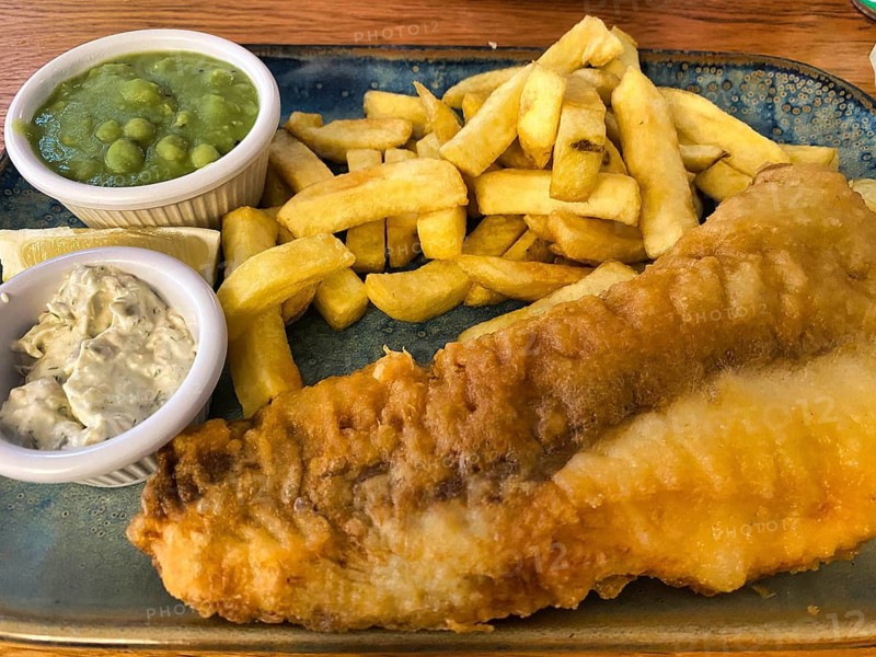 Fish and chips, fried fish in batter, french fries, pea puree, remoulade, on a plate, greasy, food, London, Great Britain, Great Britain