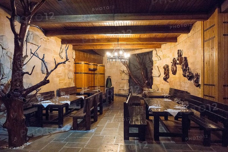 Cosy wine cellar room with rustic furnishings and warmly lit wooden elements, wine cellar, Milestii Mici Winery, Mile?tii Mici, Republic of Moldova, Moldova