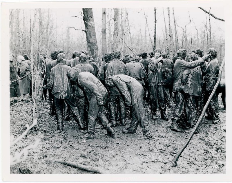 Men in muddy, fun, ritual, group of people is visible in a muddy forest area, state of chaos