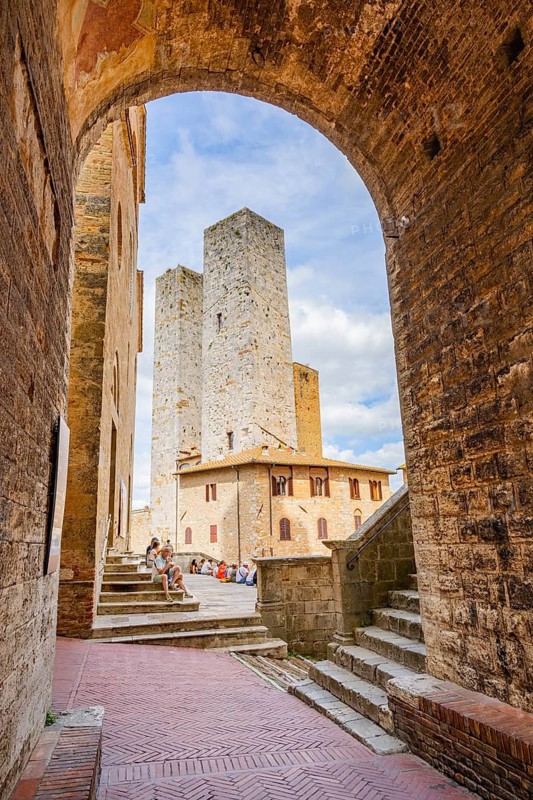 Towers of the old Town with historic buildings from Piazza del Duomo at San Gimignano on a sunny day, Tuscany, UNESCO World Heritage, Italy, Europe, Europe