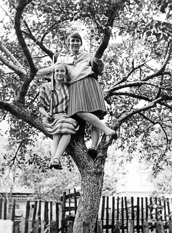 Two young woman sitting on a tree, rifle, Germany, historical, around 1930s